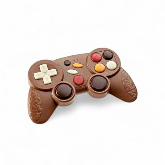 Manette de jeux vidéo en chocolat au lait de 70g, moulage gourmand détaillé pour les amateurs de gaming et de chocolat.