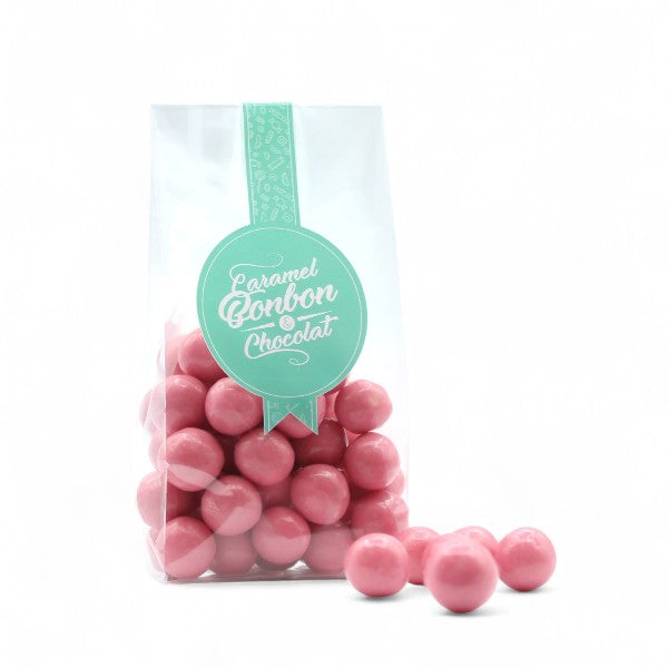 Sachet de Billes de Céréales Biscuit Rose de Reims, céréales soufflées enrobées de chocolat blanc avec poudre de biscuit rose.