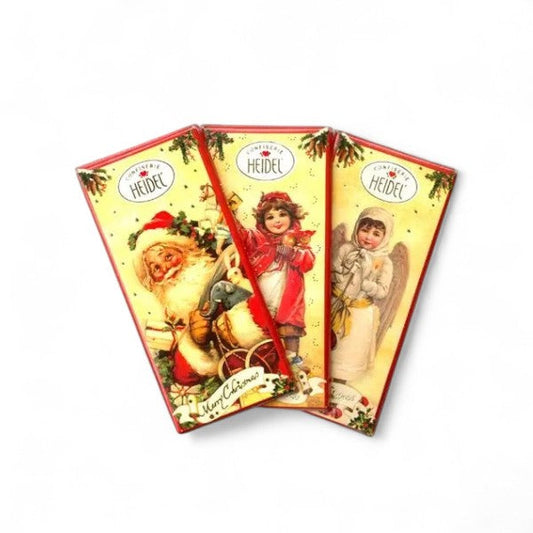 Trois tablettes de chocolat au lait “Nostalgie” de 30 g, emballées dans un papier illustré au charme rétro.