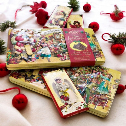 Trois boîtes décoratives “Nostalgie” de Noël 120g fermées, coffrets en métal festifs contenant des tablettes de chocolat au lait supérieur.