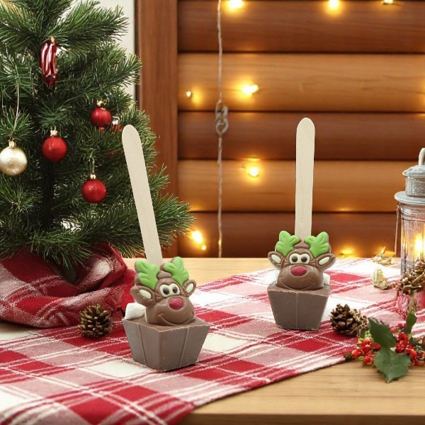 Deux cuillères à chocolat chaud Noël décor Renne 55g disposées sur une table de fête, gourmandises chocolatées et festives.