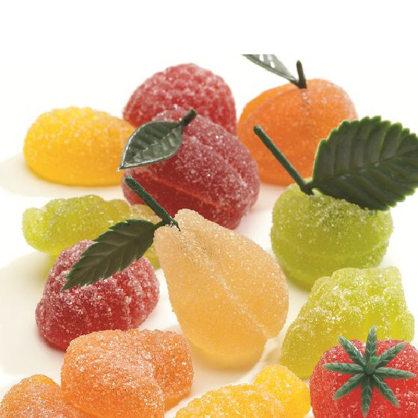 Assortiment de pâtes de fruits Luxe, confiseries fondantes en forme de fruits variés aux saveurs authentiques et gourmandes.