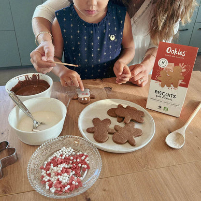 Fillette et sa maman faisant de la pâtisserie avec la préparation pour biscuits pain d’épices bio, moment familial chaleureux et gourmand.