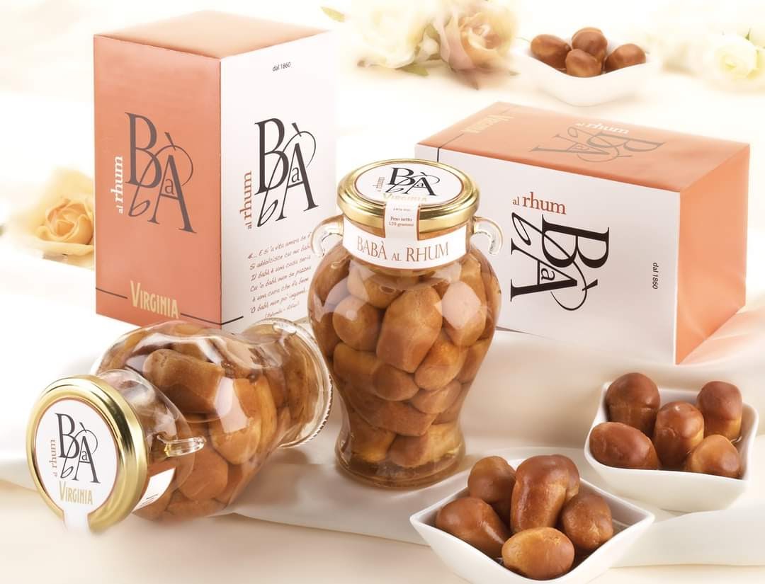 Ensemble de deux boîtes et deux pots de Baba au Rhum, dessert traditionnel moelleux au rhum doux et parfumé.